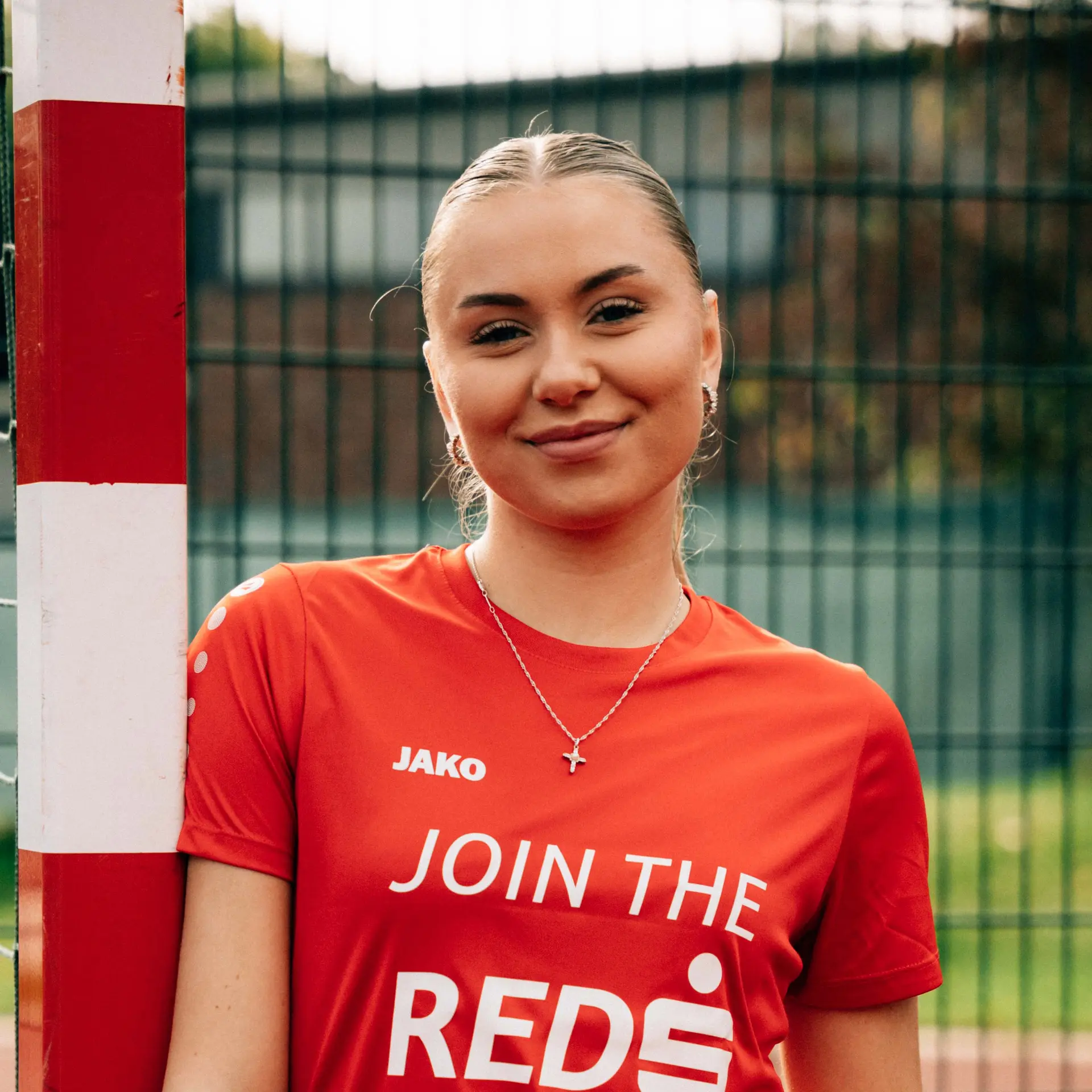 Portrait Fussballspielerin Am Sportplatzzaun